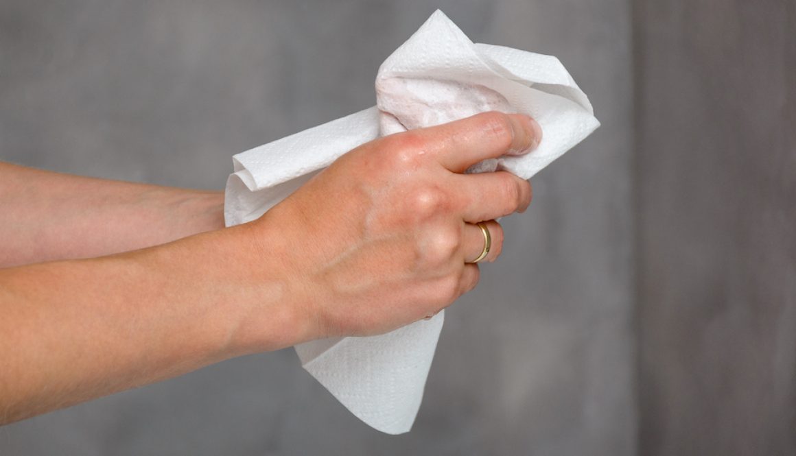 Female hands holding white towel