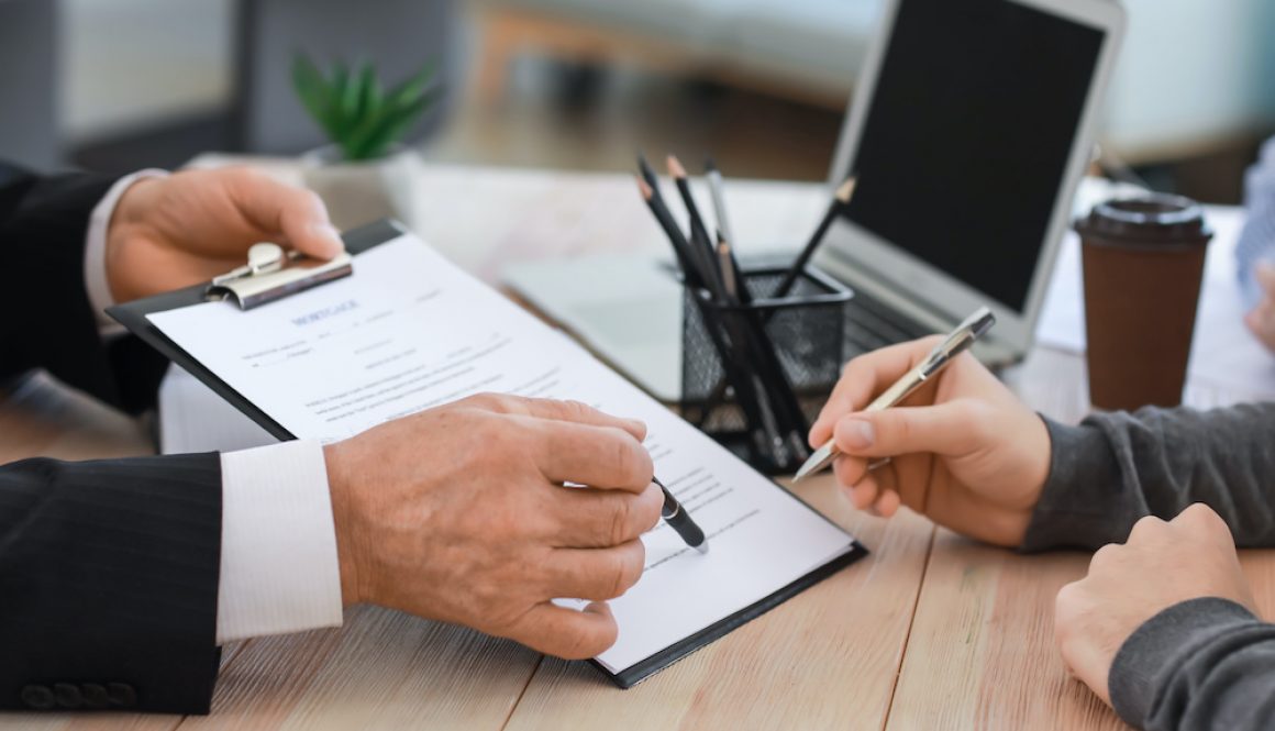 Man signing documents at notary public office