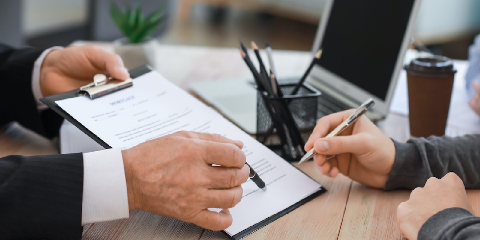 Man signing documents at notary public office