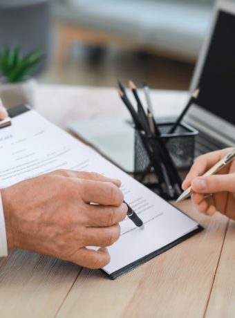 Man signing documents at notary public office