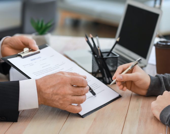 Man signing documents at notary public office