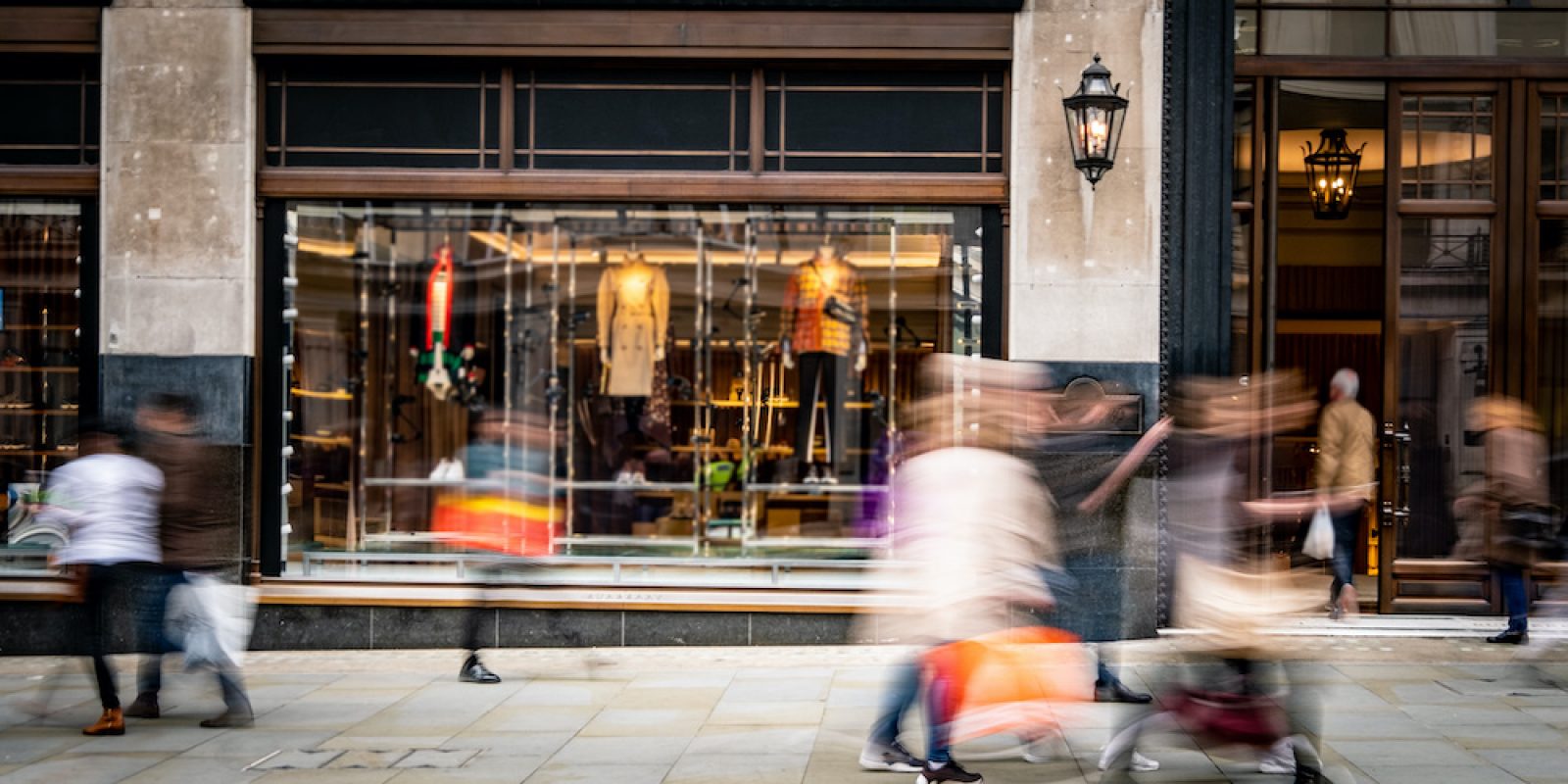 Motion blurred people walking on shopping street