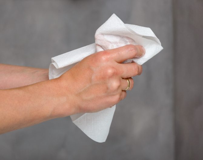 Female hands holding white towel